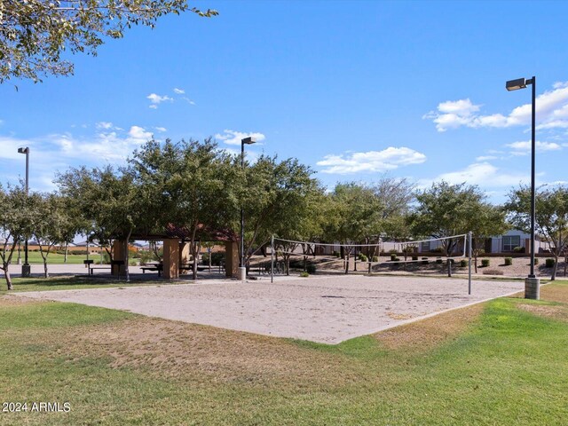 view of property's community featuring volleyball court and a lawn