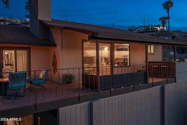 view of back house at dusk