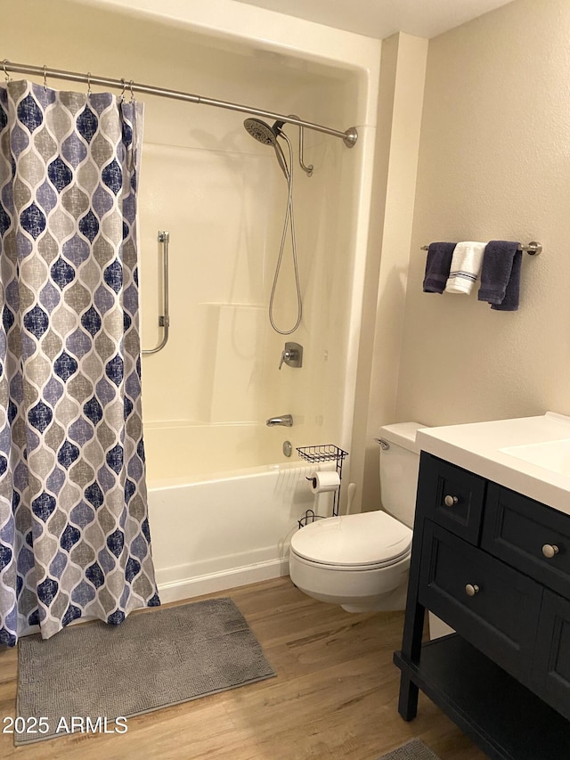 bathroom with shower / bath combination with curtain, vanity, toilet, and wood finished floors