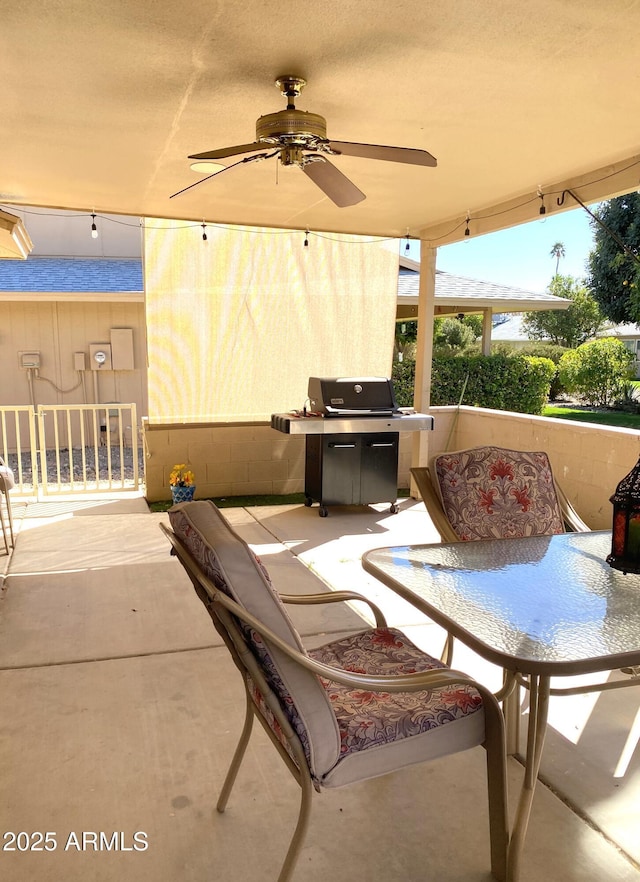 view of patio with outdoor dining area, grilling area, and a ceiling fan