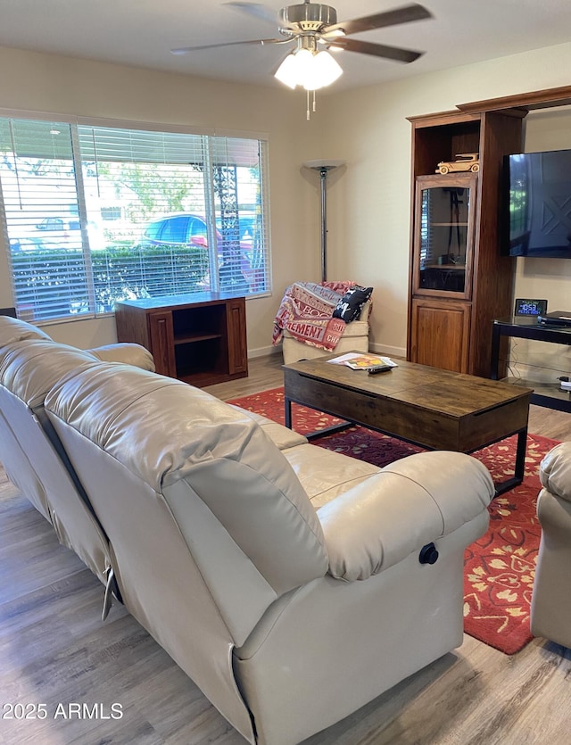 living room with plenty of natural light, ceiling fan, and wood finished floors