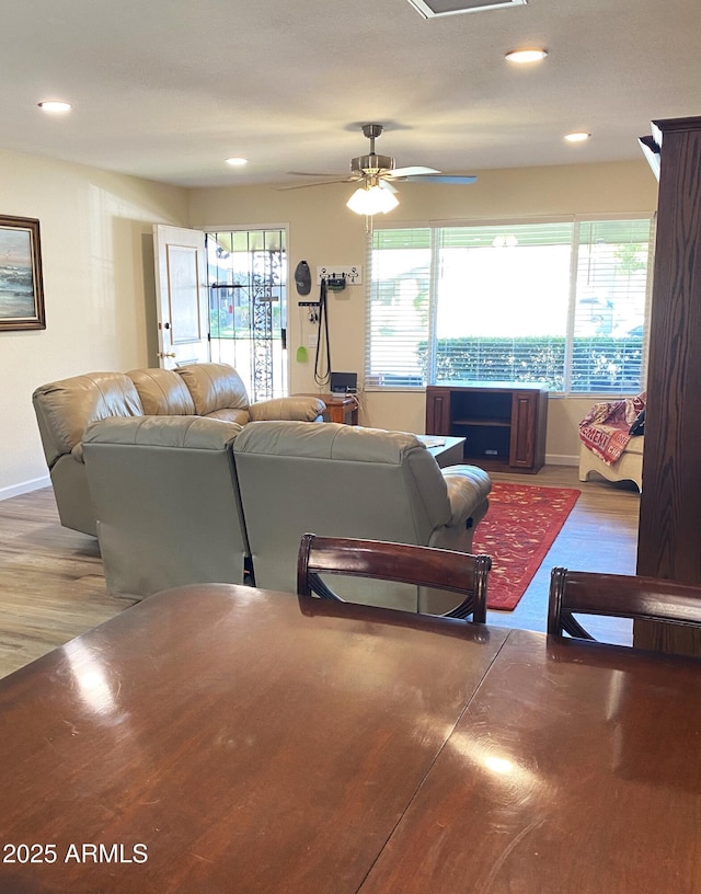 living area with recessed lighting, wood finished floors, a ceiling fan, and baseboards