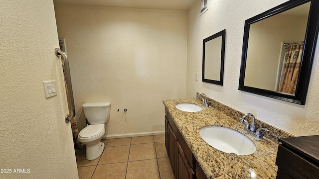 bathroom with vanity, tile patterned floors, and toilet