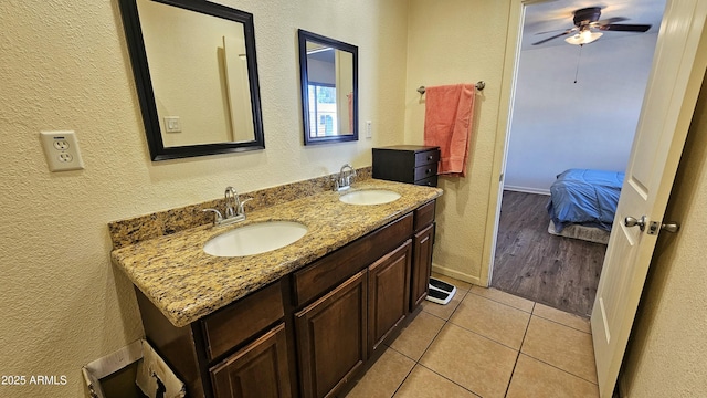 bathroom featuring ceiling fan, vanity, and tile patterned flooring