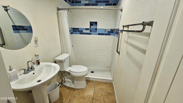 bathroom with tile patterned flooring, sink, toilet, and a shower with shower curtain