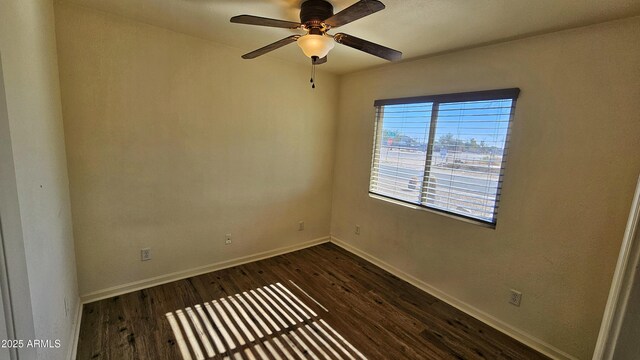 empty room featuring dark hardwood / wood-style flooring and ceiling fan