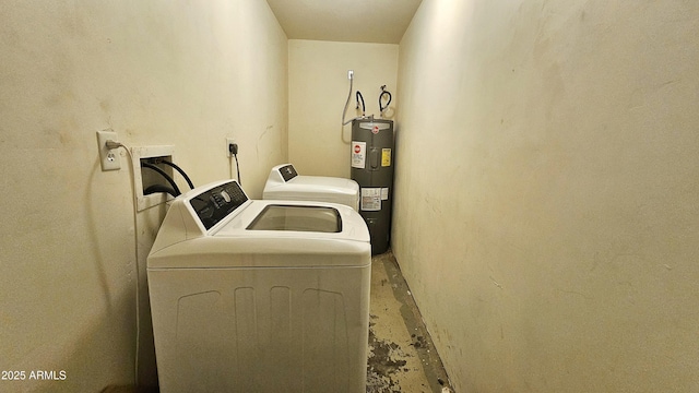 washroom with water heater and washer and dryer