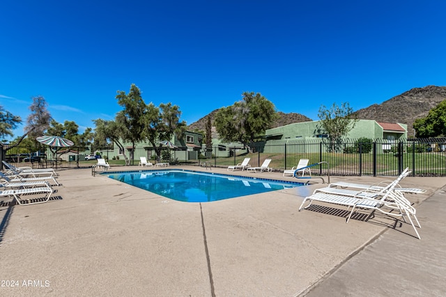 view of pool with a mountain view and a patio area