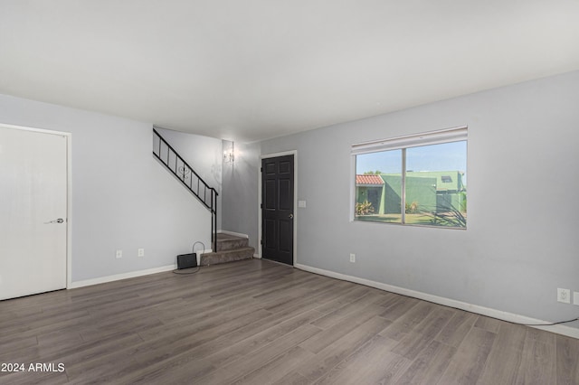 unfurnished living room with wood-type flooring