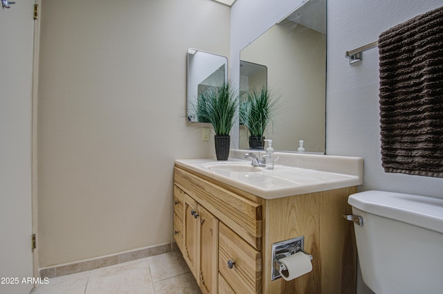 bathroom featuring vanity, tile patterned floors, toilet, and baseboards