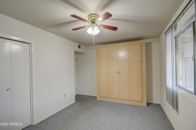 unfurnished bedroom featuring light colored carpet, visible vents, and ceiling fan