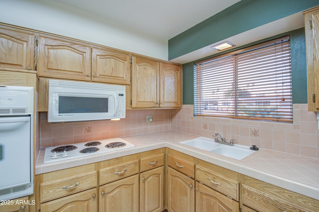 kitchen with tasteful backsplash, tile countertops, white appliances, and a sink