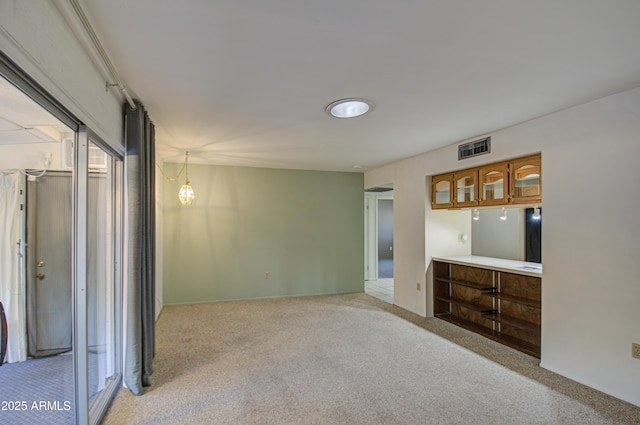 unfurnished living room with visible vents and carpet floors