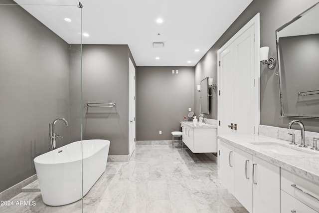 bathroom with a tub and vanity