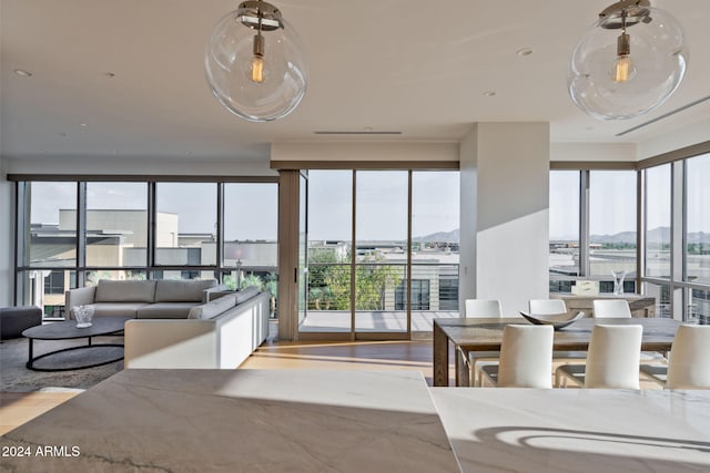 living room with light wood-type flooring and a water view