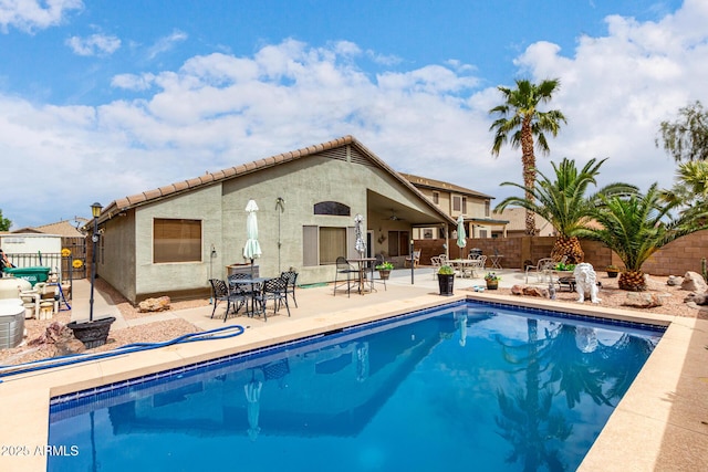 view of pool featuring a fenced in pool, a patio, a fenced backyard, and ceiling fan