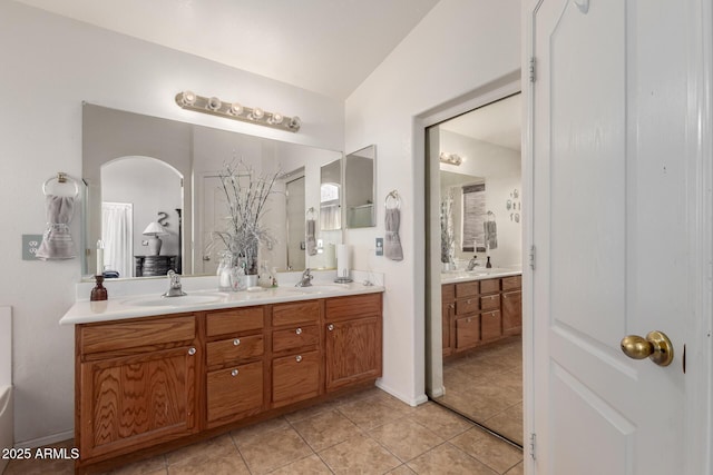 bathroom featuring double vanity, tile patterned floors, and a sink
