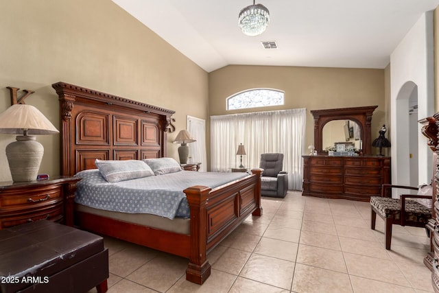 bedroom with light tile patterned flooring, arched walkways, visible vents, and high vaulted ceiling