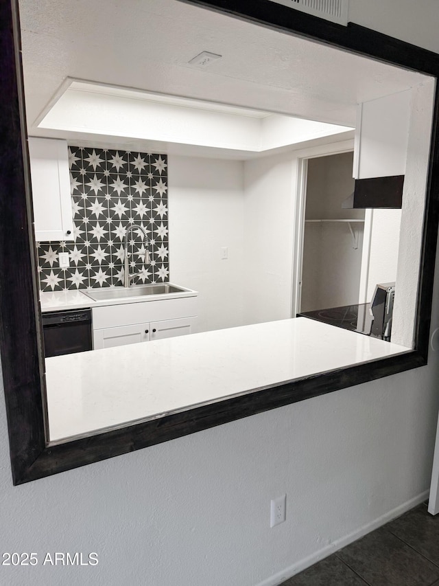 5975 N 48th Dr, Glendale, AZ 85301 - kitchen featuring black dishwasher, a sink, white cabinetry, tile patterned flooring, and backsplash
