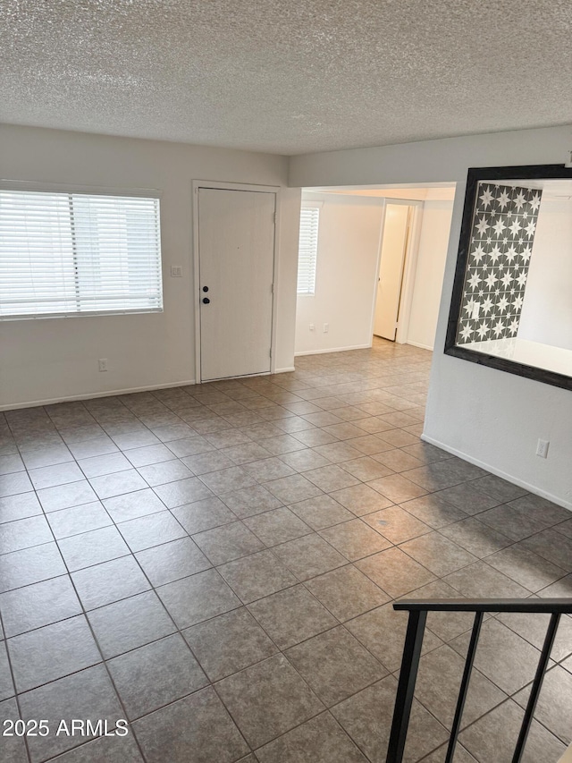 5975 N 48th Dr, Glendale, AZ 85301 - tiled spare room with a textured ceiling and baseboards