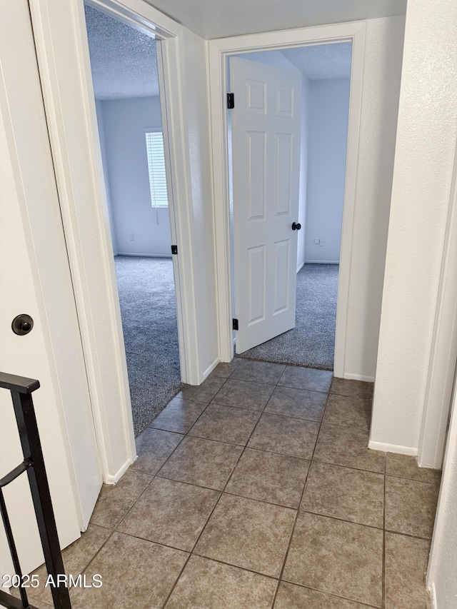 5975 N 48th Dr, Glendale, AZ 85301 - corridor with carpet, tile patterned flooring, baseboards, and a textured ceiling