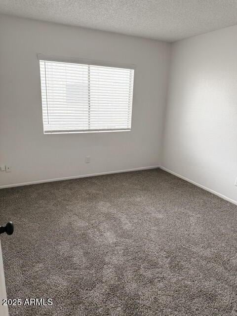5975 N 48th Dr, Glendale, AZ 85301 - spare room with carpet, a textured ceiling, and baseboards