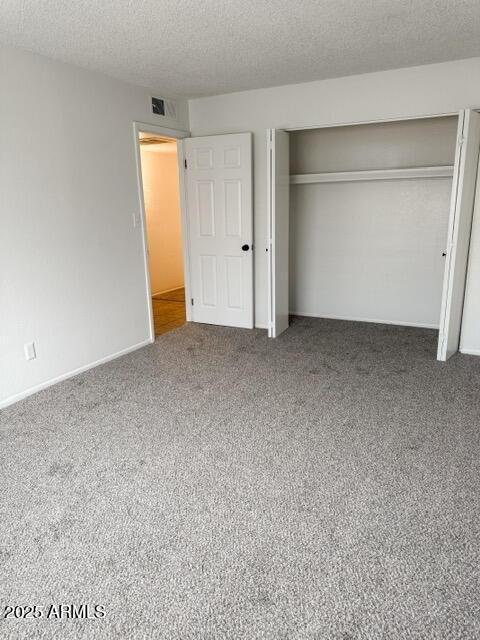 5975 N 48th Dr, Glendale, AZ 85301 - unfurnished bedroom featuring carpet, a closet, and a textured ceiling