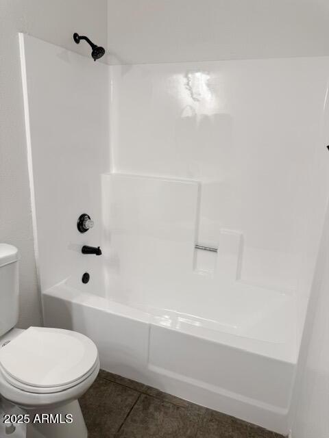 5975 N 48th Dr, Glendale, AZ 85301 - bathroom featuring toilet, shower / washtub combination, and tile patterned floors