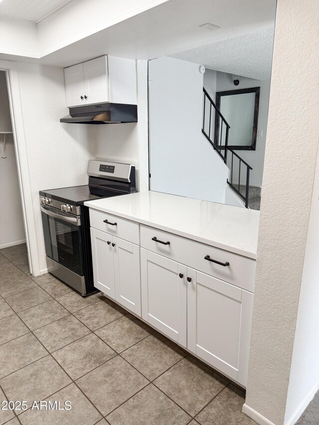 5975 N 48th Dr, Glendale, AZ 85301 - kitchen featuring electric range, under cabinet range hood, white cabinetry, and light countertops