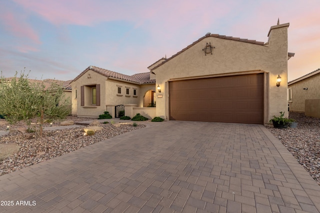 mediterranean / spanish-style house with a garage