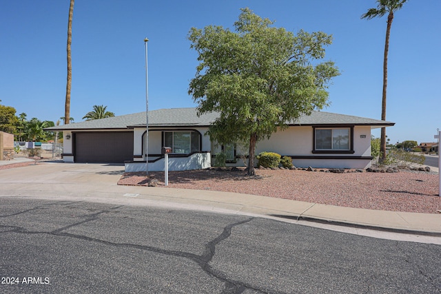 ranch-style house featuring a garage