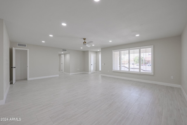 spare room featuring ceiling fan and light hardwood / wood-style floors