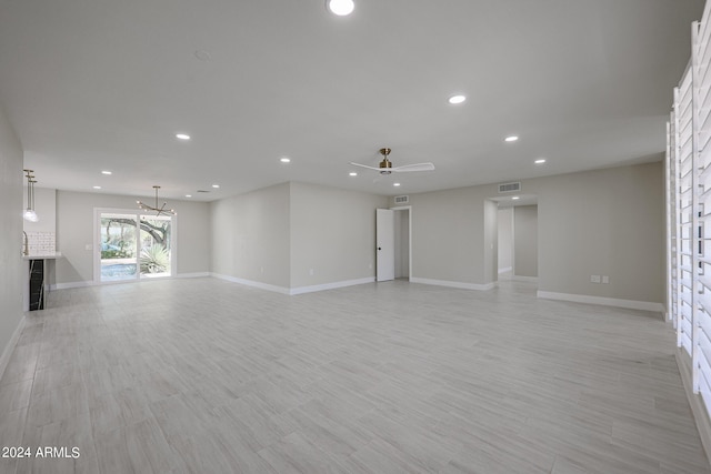 spare room with light wood-type flooring and ceiling fan