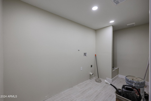 washroom featuring light wood-type flooring, hookup for a washing machine, and hookup for an electric dryer