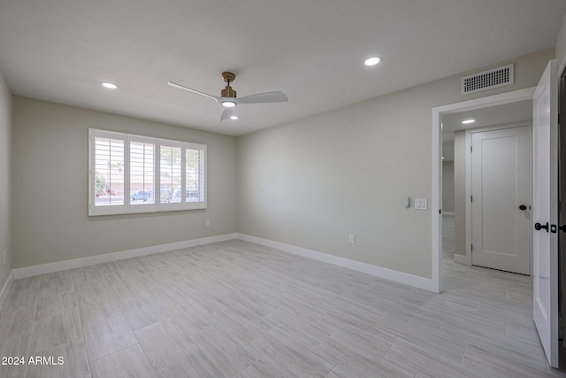 empty room with ceiling fan and light wood-type flooring