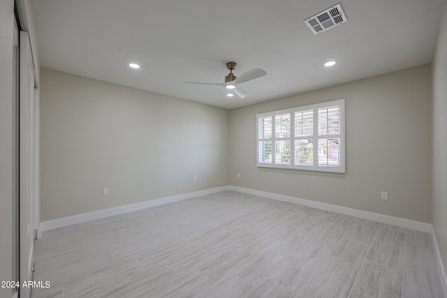 spare room with ceiling fan and light wood-type flooring