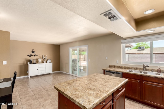 3415 E Anderson Dr, Phoenix, AZ 85032 - kitchen featuring a sink, dishwasher, light tile patterned floors, a kitchen island, and a textured ceiling