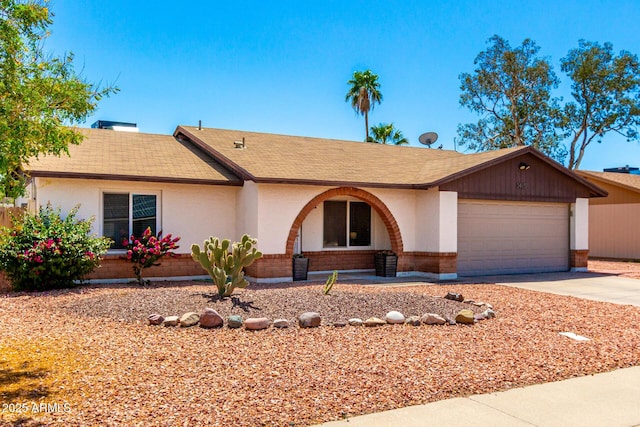 3415 E Anderson Dr, Phoenix, AZ 85032 - ranch-style house featuring a shingled roof, driveway, an attached garage, stucco siding, and brick siding