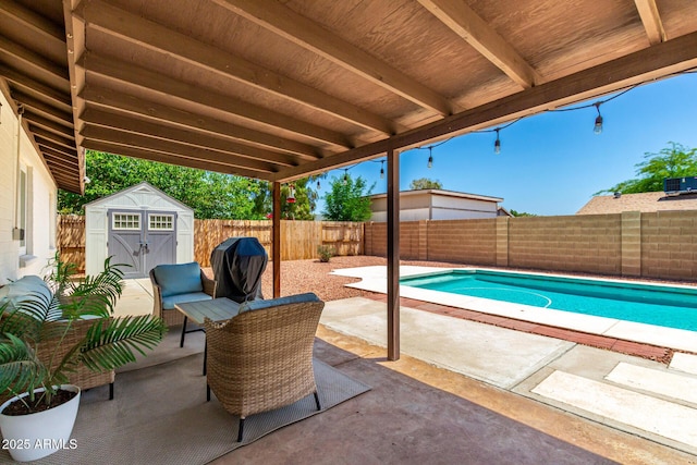 3415 E Anderson Dr, Phoenix, AZ 85032 - view of patio with a storage unit, a fenced backyard, and an outbuilding