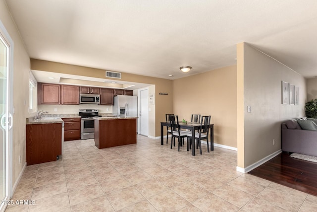 3415 E Anderson Dr, Phoenix, AZ 85032 - kitchen featuring stainless steel appliances, a sink, open floor plan, a center island, and light tile patterned floors