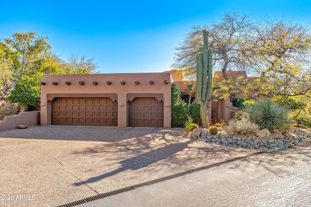 southwest-style home featuring a garage