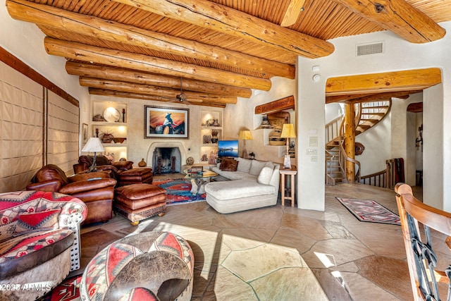 living room featuring wood ceiling, ceiling fan, and beamed ceiling