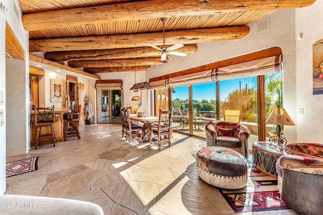 living room with ceiling fan, wooden ceiling, and beamed ceiling