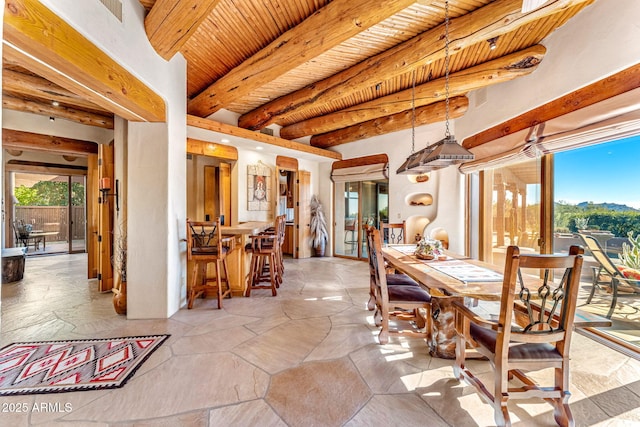 dining space featuring beam ceiling and wooden ceiling