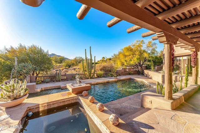 view of pool with an in ground hot tub and a patio