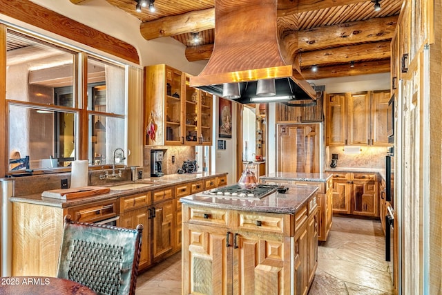 kitchen featuring sink, wood ceiling, a center island, stone counters, and stainless steel appliances