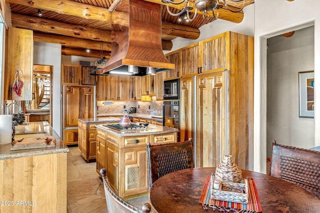 kitchen featuring sink, built in appliances, a kitchen island, decorative backsplash, and beamed ceiling