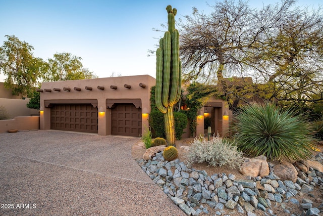 southwest-style home featuring a garage