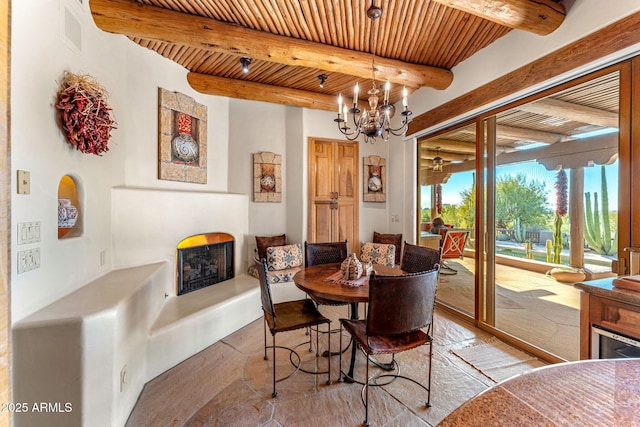 dining space with beamed ceiling, a notable chandelier, and wood ceiling