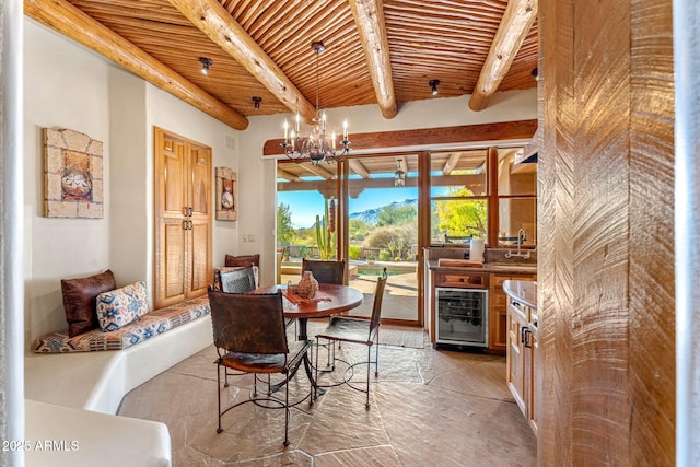 dining space with beam ceiling, a notable chandelier, wood ceiling, and beverage cooler